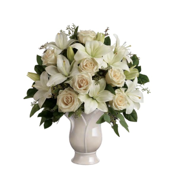 White lilies and cream roses arranged in a vase