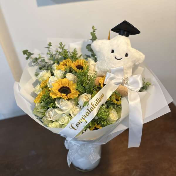 Sunflower and white rose bouquet with a graduation plush and ribbon