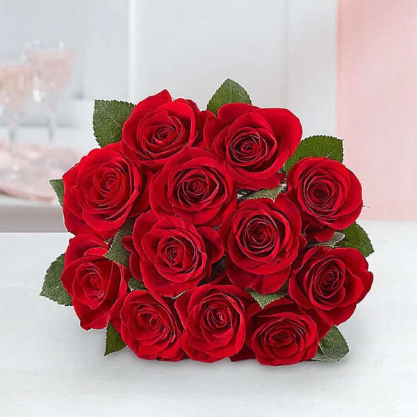 Bouquet of red roses with green leaves