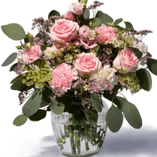 Pink roses and carnations in a clear glass vase