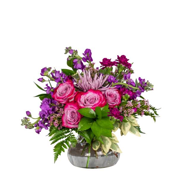 Pink and purple flower arrangement in a glass vase