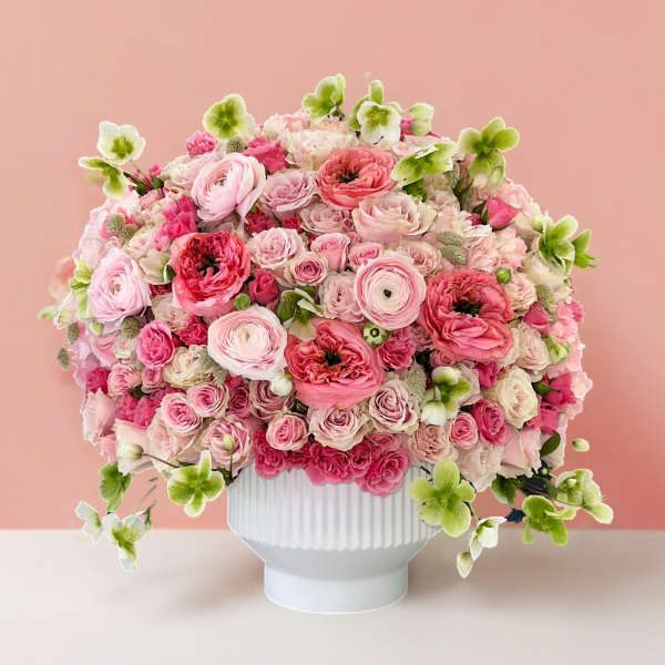 Pink and white flower arrangement in a white vase