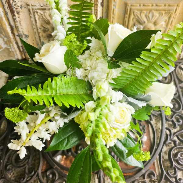 White floral bouquet with roses and green fern fronds