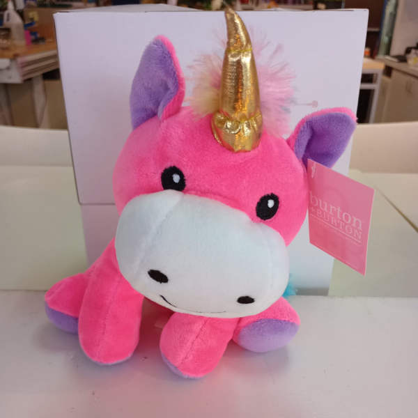 Pink plush unicorn toy with a gold horn and purple ears