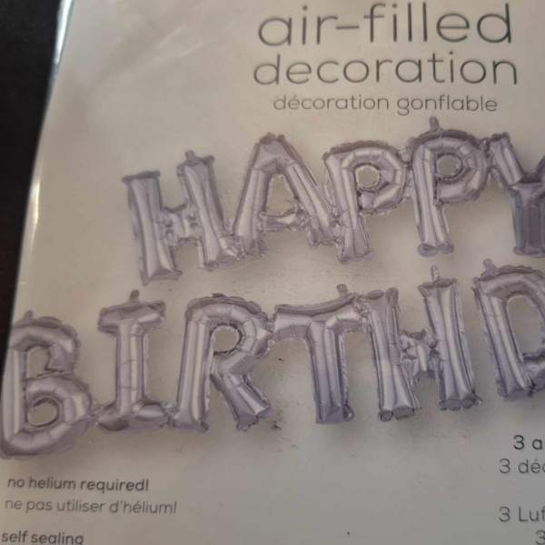 Silver birthday letter balloons spelling Happy Birthday