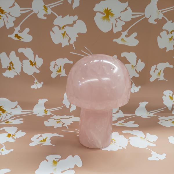 Pink mushroom-shaped decorative object on a floral patterned background