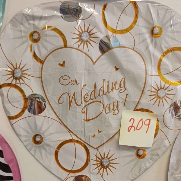 Heart-shaped wedding day balloon with gold circle and starburst pattern