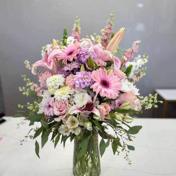 Pink and white mixed bouquet in a clear glass vase