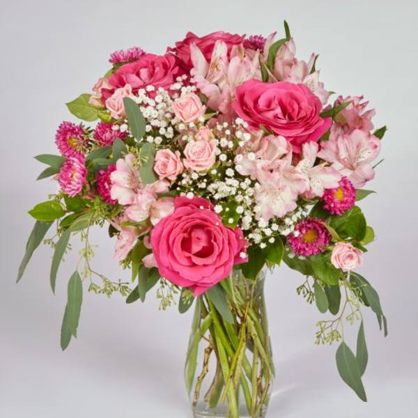 Pink roses and alstroemeria in a clear glass vase