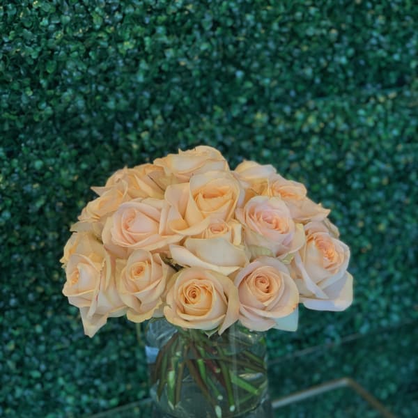 Bouquet of pale peach roses in a clear glass vase