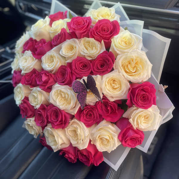 Bouquet of pink and cream roses with a butterfly decoration