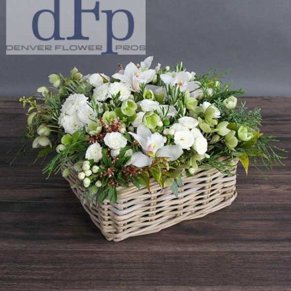 White floral arrangement in a wicker basket