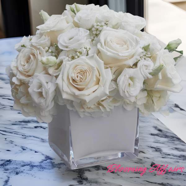 White rose bouquet in a clear square vase
