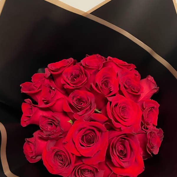 Bouquet of red roses wrapped in black paper