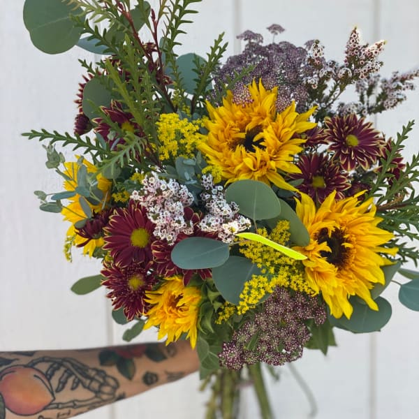 Hand-tied bouquet of yellow sunflowers and burgundy chrysanthemums