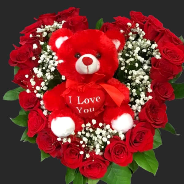 Heart-shaped bouquet of red roses with a red teddy bear in the center