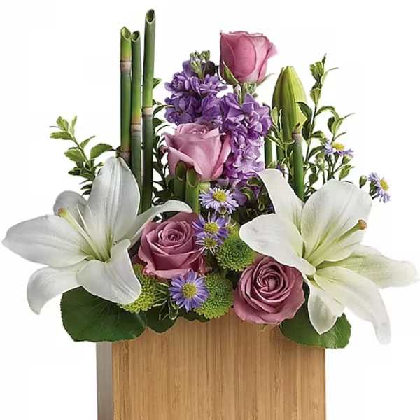 Pink roses and white lilies arranged in a wooden box