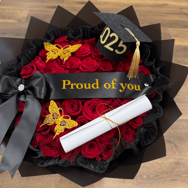 Red rose bouquet with a black graduation cap and diploma scroll