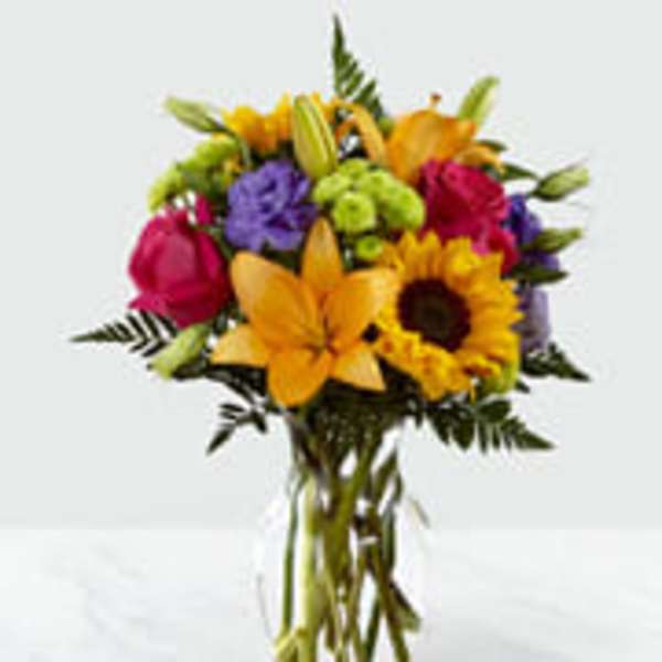Bouquet of mixed flowers in a clear glass vase