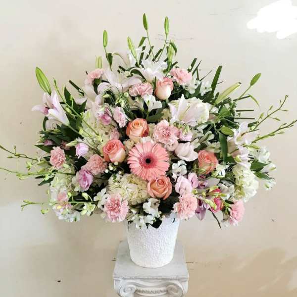 Pink and white floral arrangement in a white vase