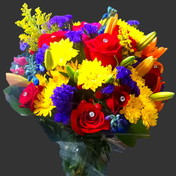 Colorful bouquet of roses, lilies, and daisies in clear wrap