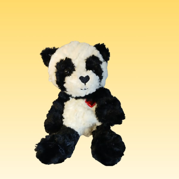 Black-and-white plush panda bear with a red heart on its chest