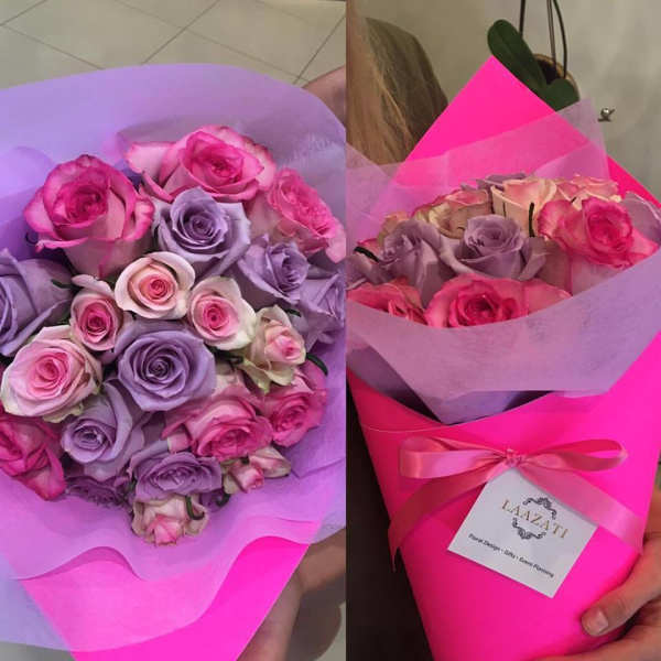 Two bouquets of pink and lavender roses wrapped in bright paper