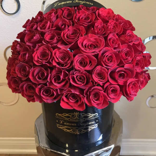 Large bouquet of red roses in a black hatbox