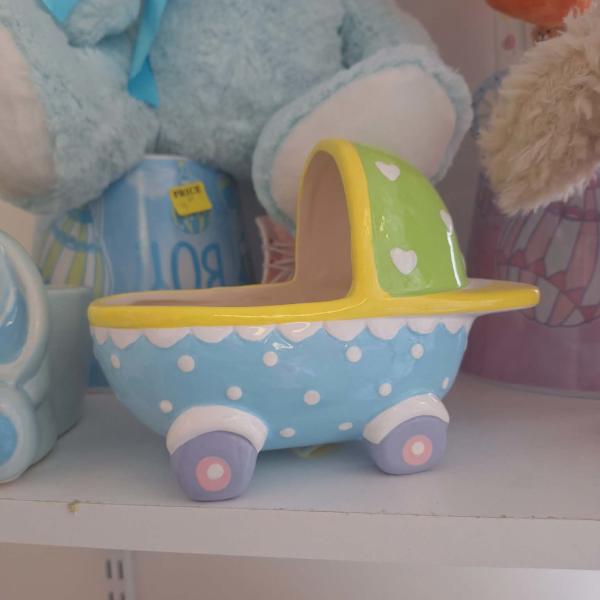 Pastel ceramic planter shaped like a baby carriage
