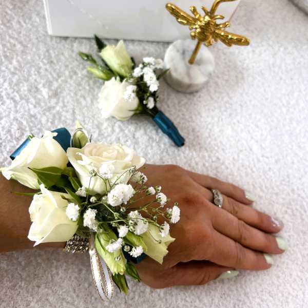 White rose wrist corsage with baby's breath and ribbon
