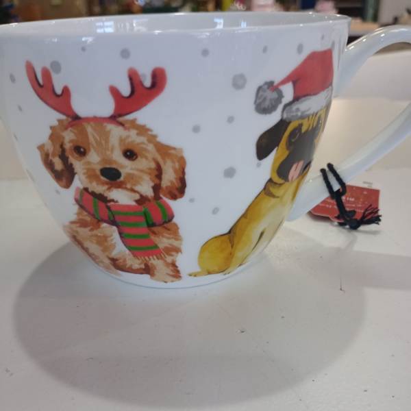 White mug with holiday dog illustrations and a red Santa hat