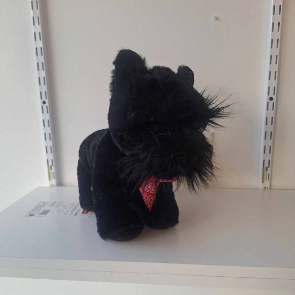 Black plush cat figurine with a red bandana