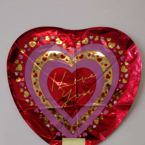 Heart-shaped red foil balloon with "Love You" text