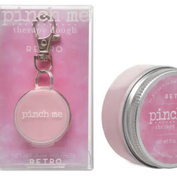 Pink therapy dough tin and matching keychain in clear packaging