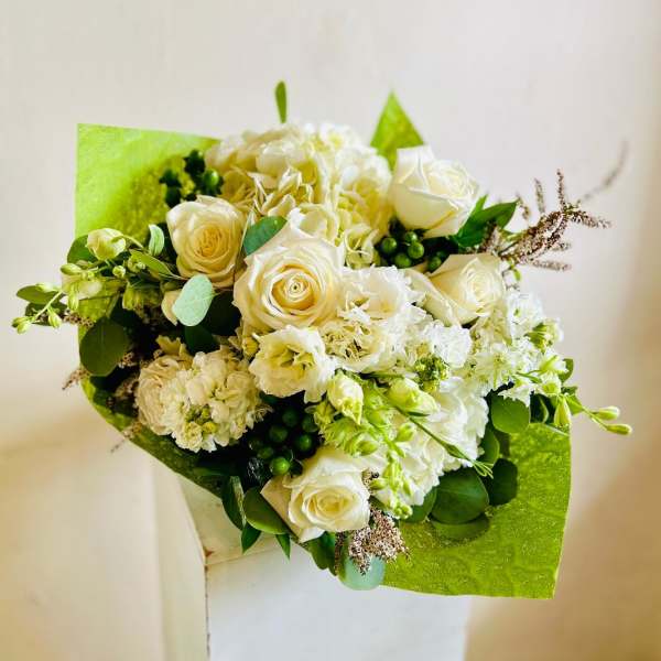 White roses and hydrangeas in bright green wrapping