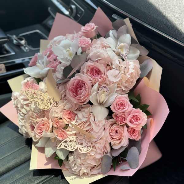 Pink roses and hydrangeas bouquet with white orchids and butterfly accents
