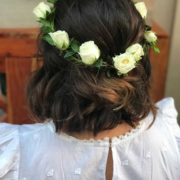 White rose flower crown on a woman's dark hair
