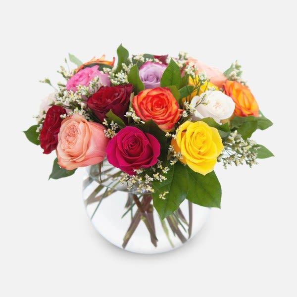 Mixed roses in a clear glass vase