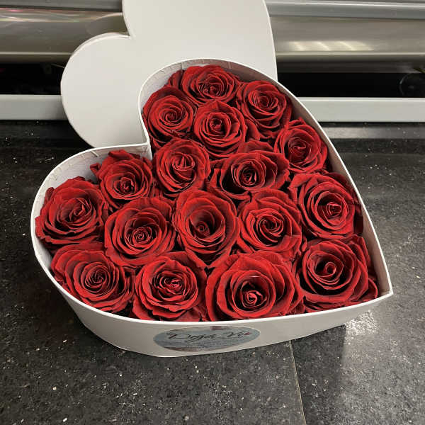Heart-shaped box filled with red roses