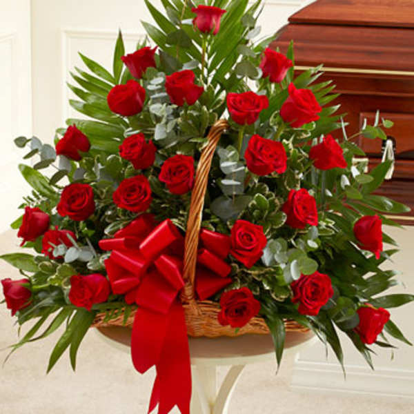 Basket arrangement of red roses with a red ribbon