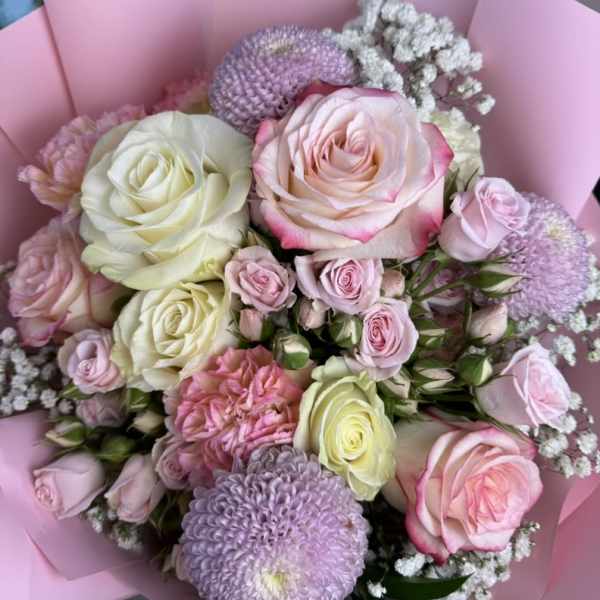 Pink and white rose bouquet with lavender blooms wrapped in pink paper