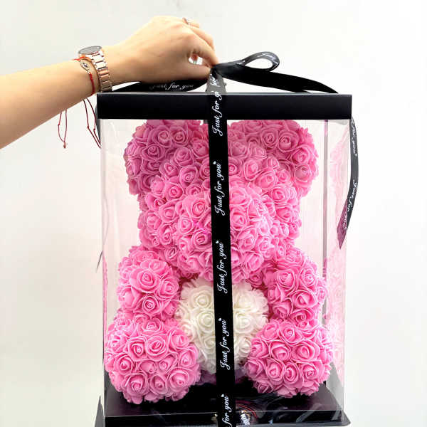 Pink rose teddy bear in a clear gift box with a black ribbon