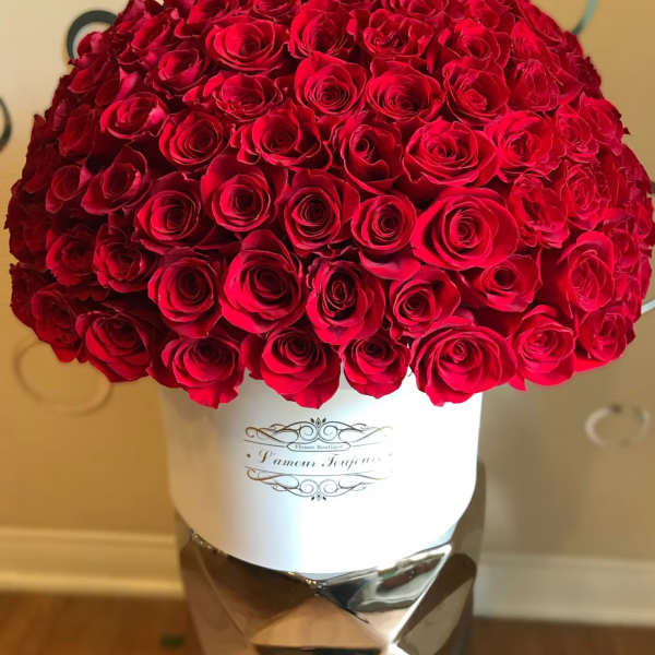 Large bouquet of red roses in a white hatbox