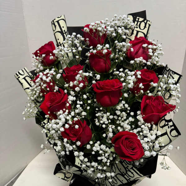 Bouquet of red roses with white baby's breath and black patterned wrap