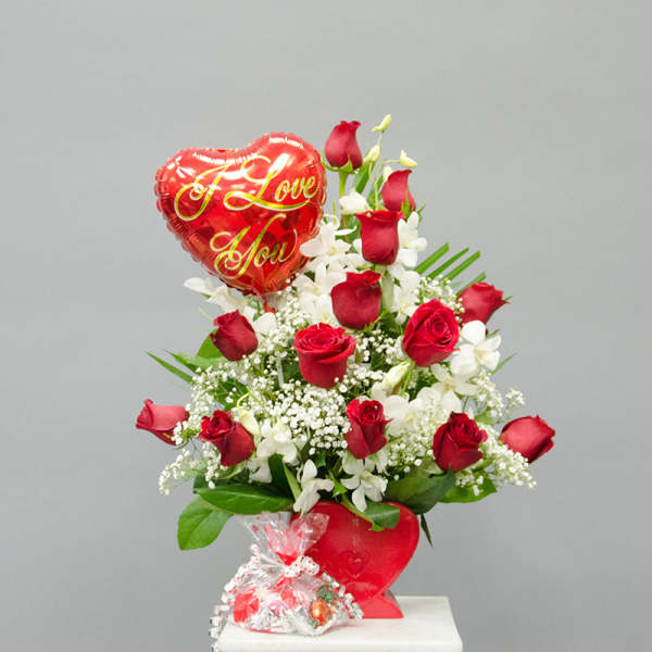 Red roses and white flowers with a heart-shaped "I Love You" balloon