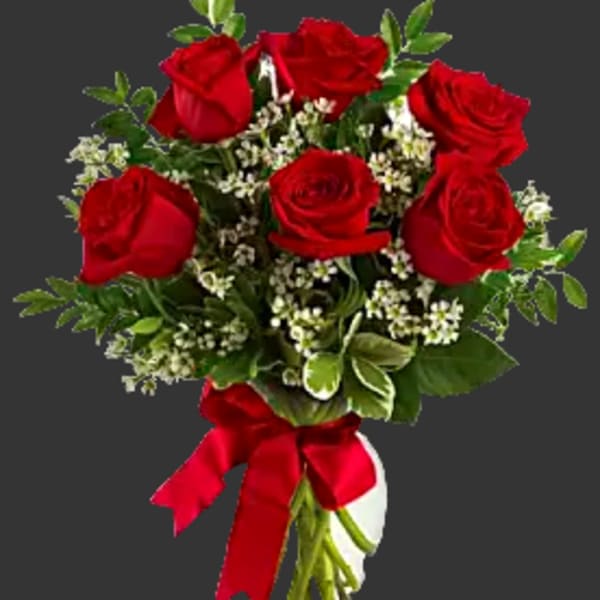 Bouquet of red roses with white filler flowers and a red ribbon