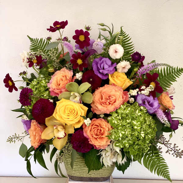 Colorful mixed flower arrangement in a low ceramic vase