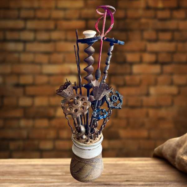 Decorative metal sculpture in a ceramic vase