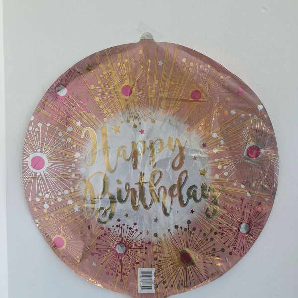 Round pink foil balloon with "Happy Birthday" text