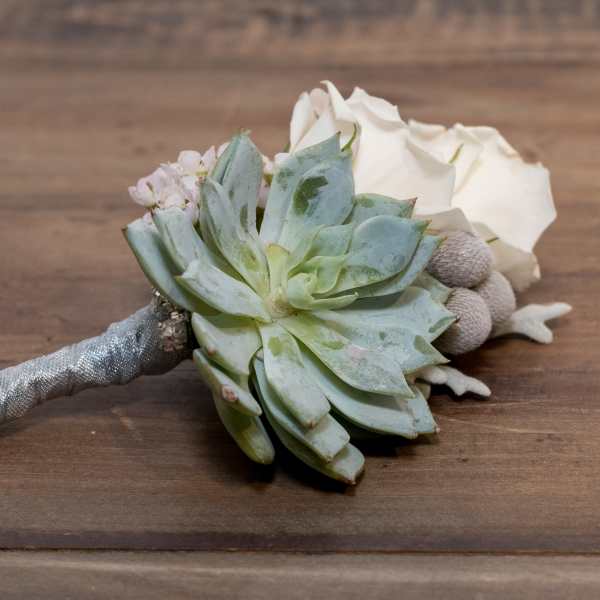Succulent bouquet with white roses and a silver wrapped handle
